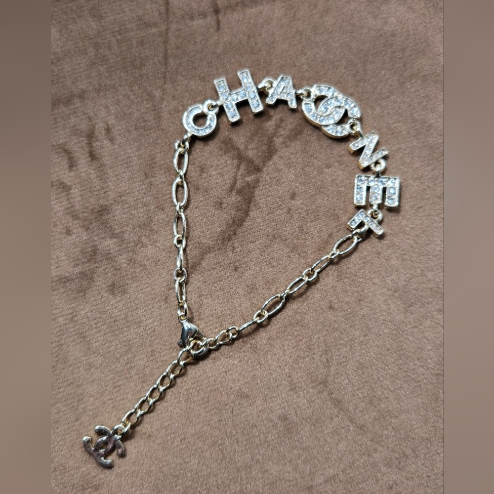 Gold Tone Logo Bracelet With Rocks